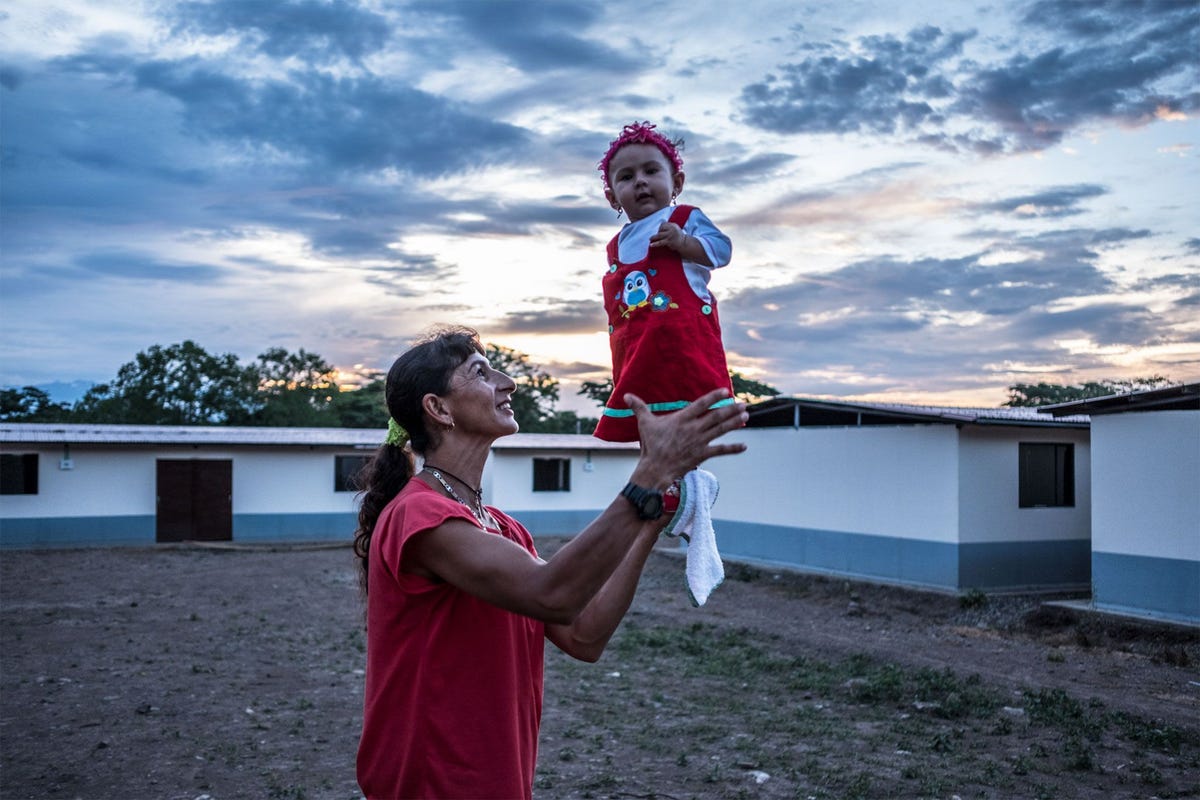 Former FARC fighter Esperanza Medina holds her sevenmonthold daughter Desiree Paz at the transitional and normalization zone in Pondores La Guajira Colombia