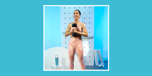 trainer kristina earnest holding a dumbbell in front of her chest with both hands
