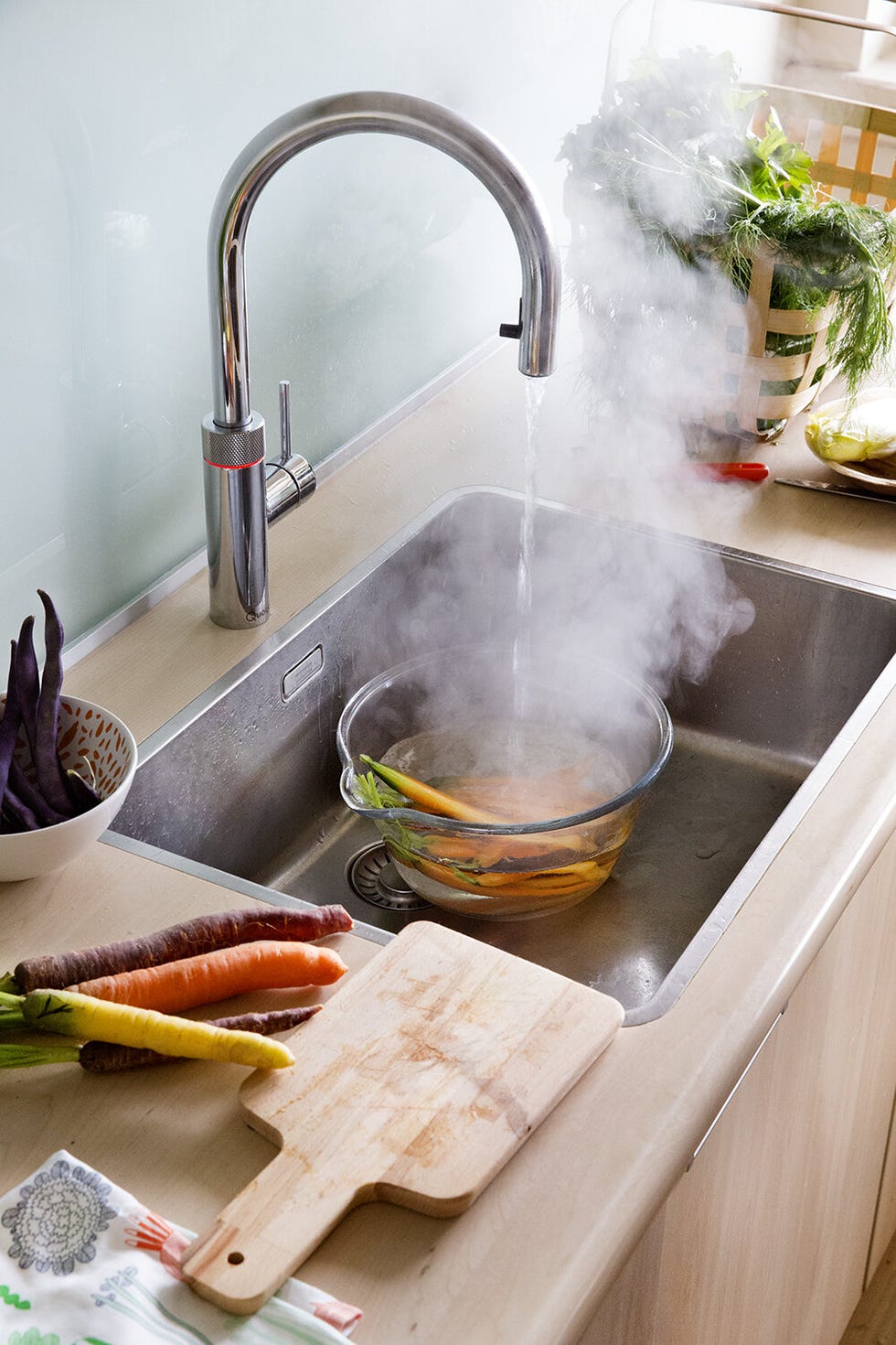 preparing vegetables in a modern kitchen sink