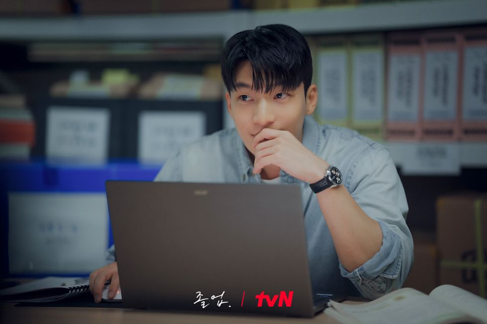 a person sitting at a desk with a laptop
