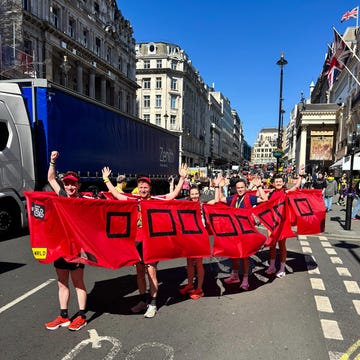 group of five runners standing in a bus costume on a street in london group of five runners standing in a bus costume on a street in london