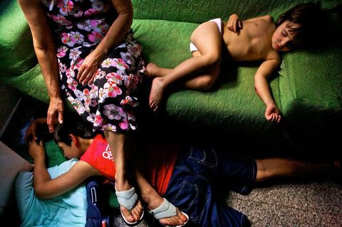 Op Sardini Itali kijkt een grootmoeder toe hoe haar twee jonge kleinkinderen slapen