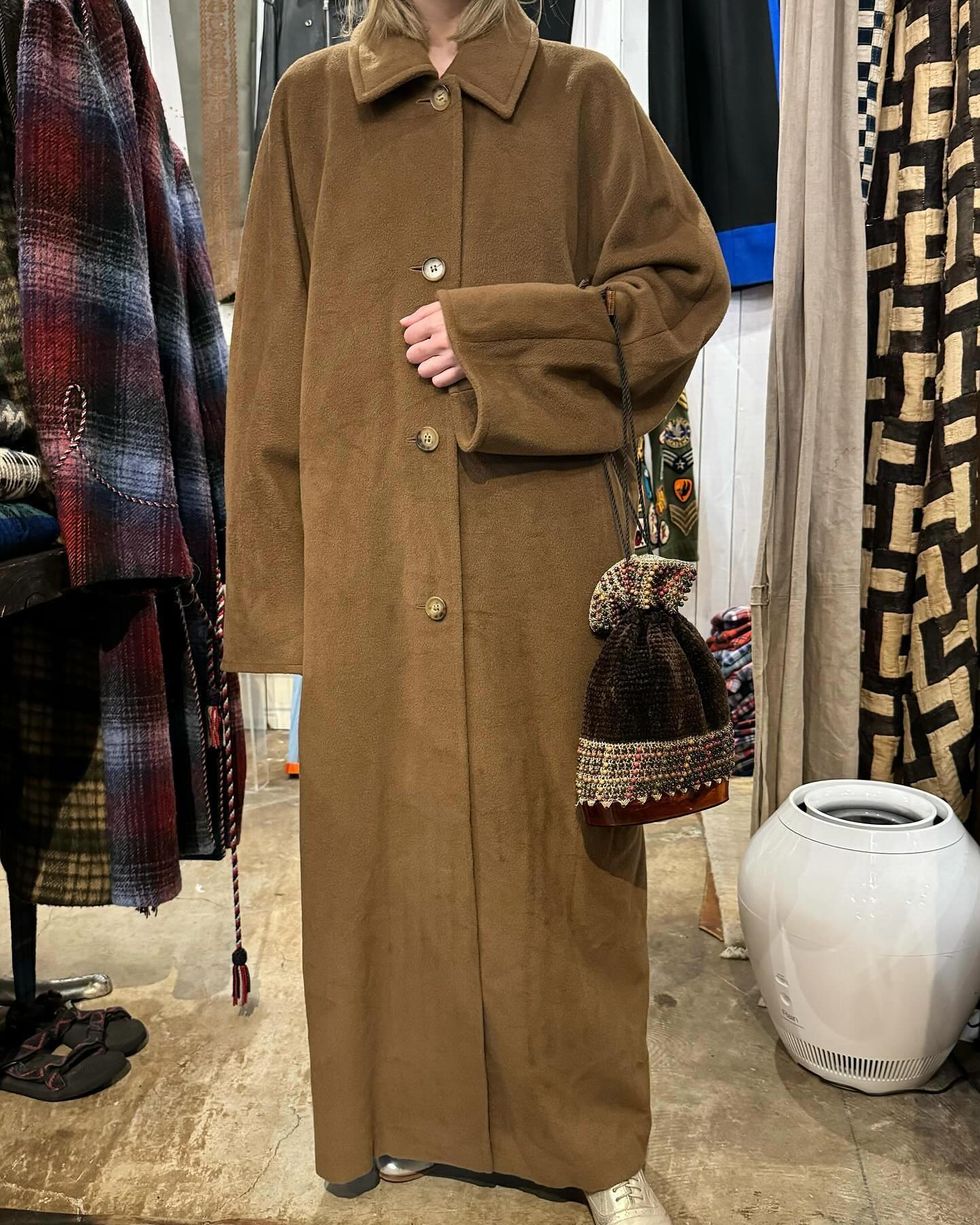 a man wearing a brown coat