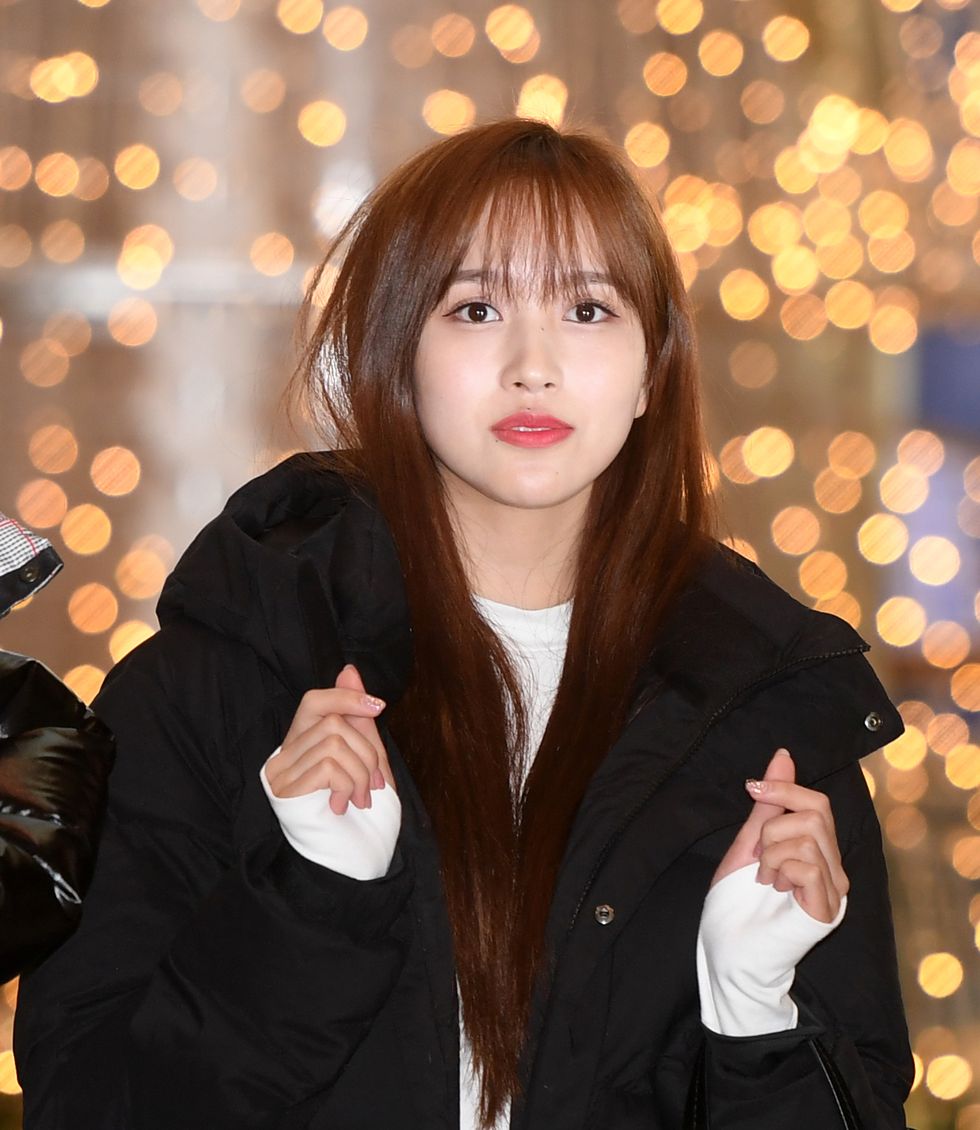 twicemina poses for pictures after she arrived at kimpo international airport on december 20th in kimpo, south korea photoosen