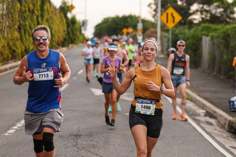 a group of people running on a road in a race