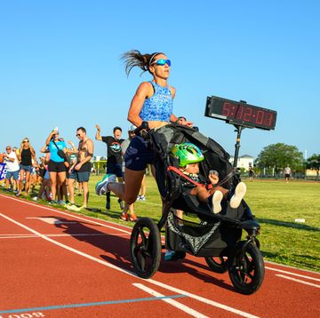 woman pushing stroller on a track
