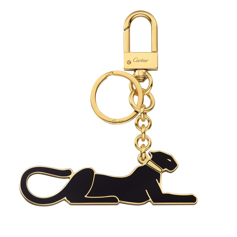 diabolo de cartier key ring in lacquered gold finish metal with panthère motif 
dimensions w 96 x h 30 mm