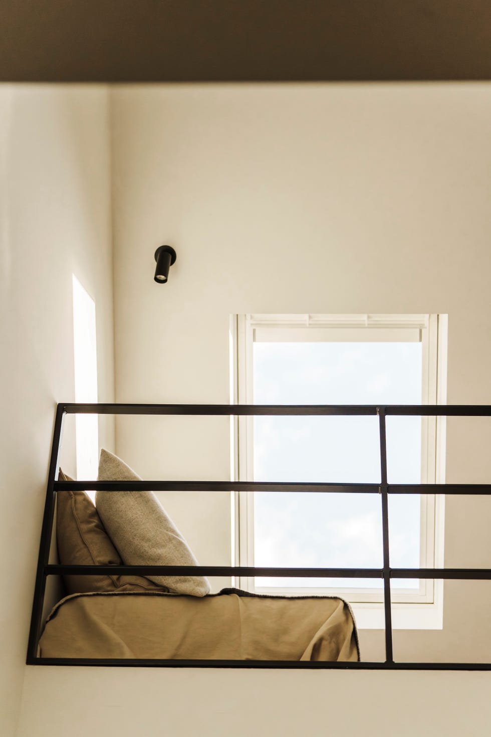 a loft space in the factory house in muiden, the netherlands, bathed in natural light from a velux roof window