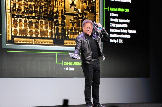 jensen huang, head of chip manufacturer nvidia, shows a prototype of the new chip called drive xavier for autonomous driving during the technological fair ces 2018 in las vegas, usa, 8 january 2018 photo andrej sokolowdpa photo by andrej sokolowpicture alliance via getty images
