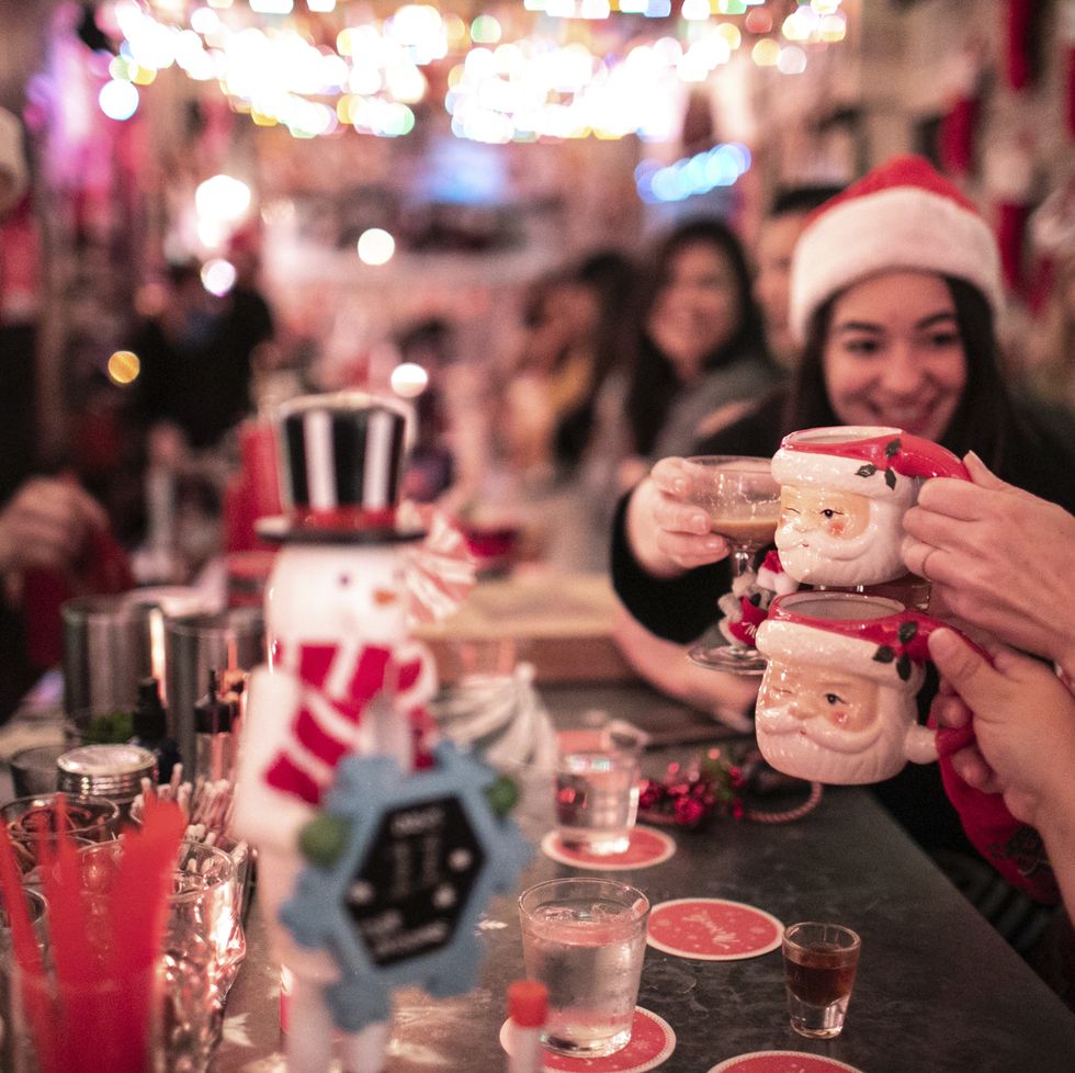 a group of people holding cups with christmas decorations
