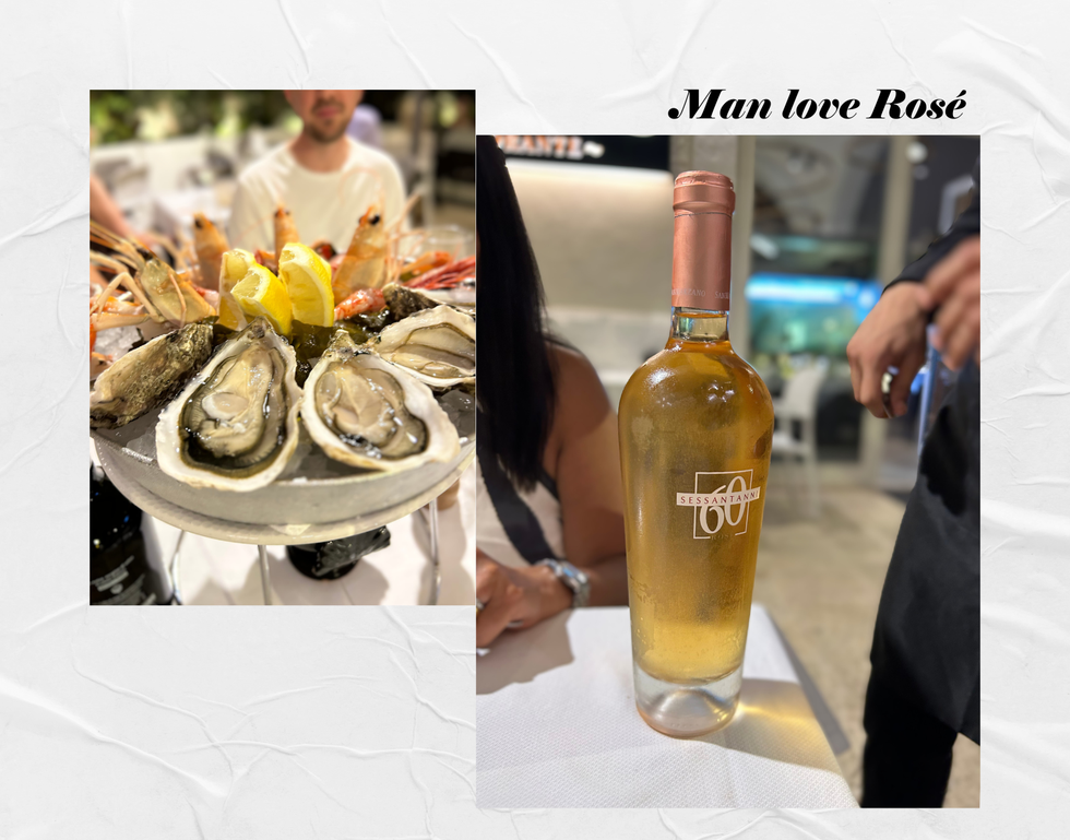 a bottle of alcohol next to a plate of oysters