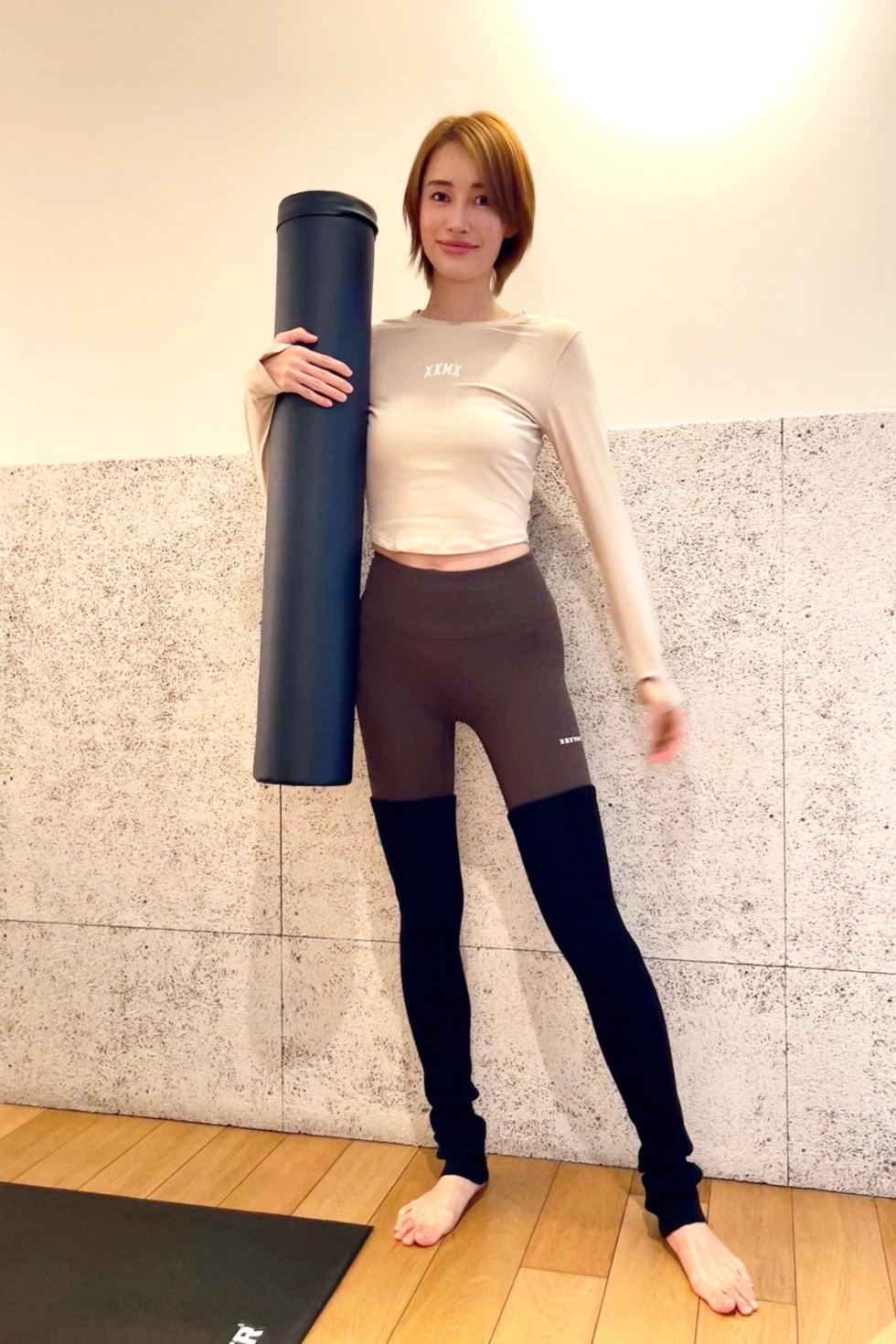 a woman holding a black pole