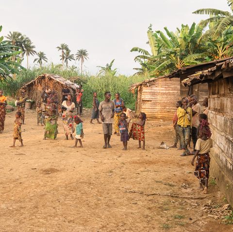 a group of people walking around a village
