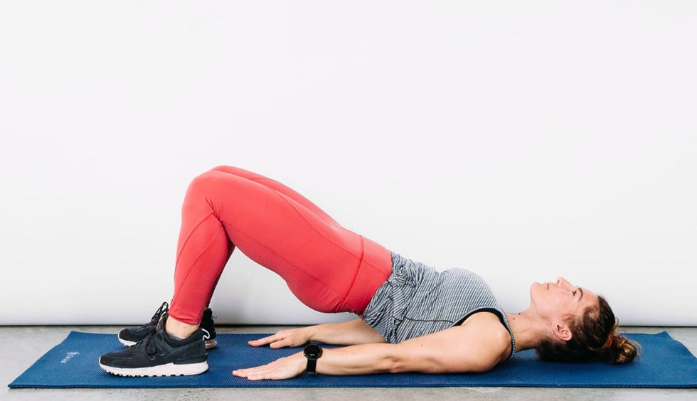 demonstration of a bridge exercise on a yoga mat