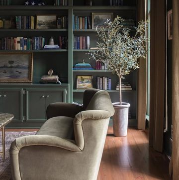 a chair in front of a bookcase