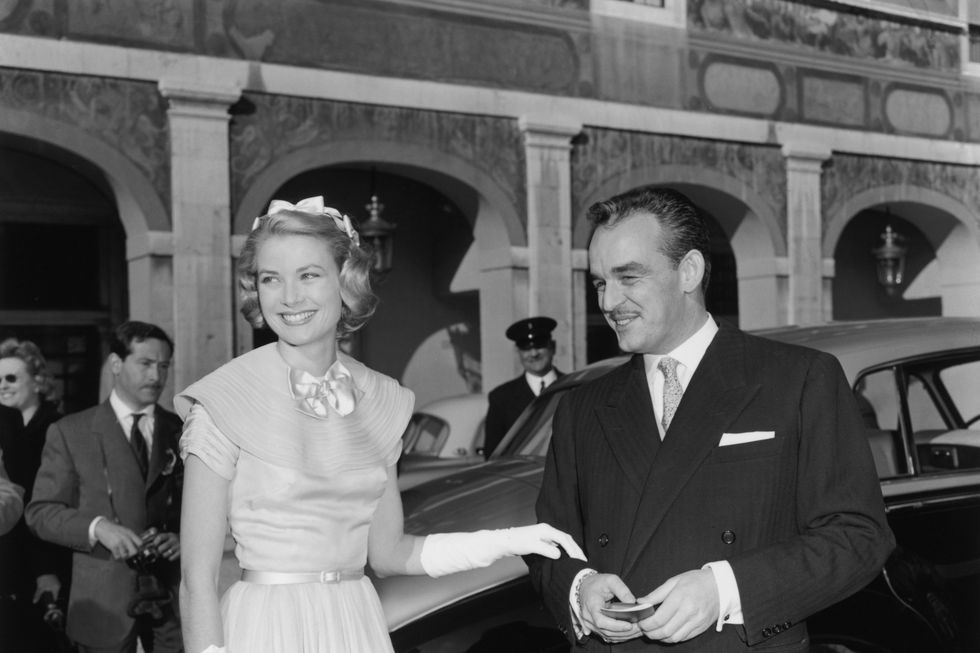 Grace Kelly and Prince Rainier III greet well-wishers in the palace courtyard in Monte Carlo prior to their wedding, April 18, 1956.