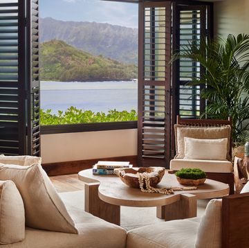 a living room with a view of the ocean and mountains