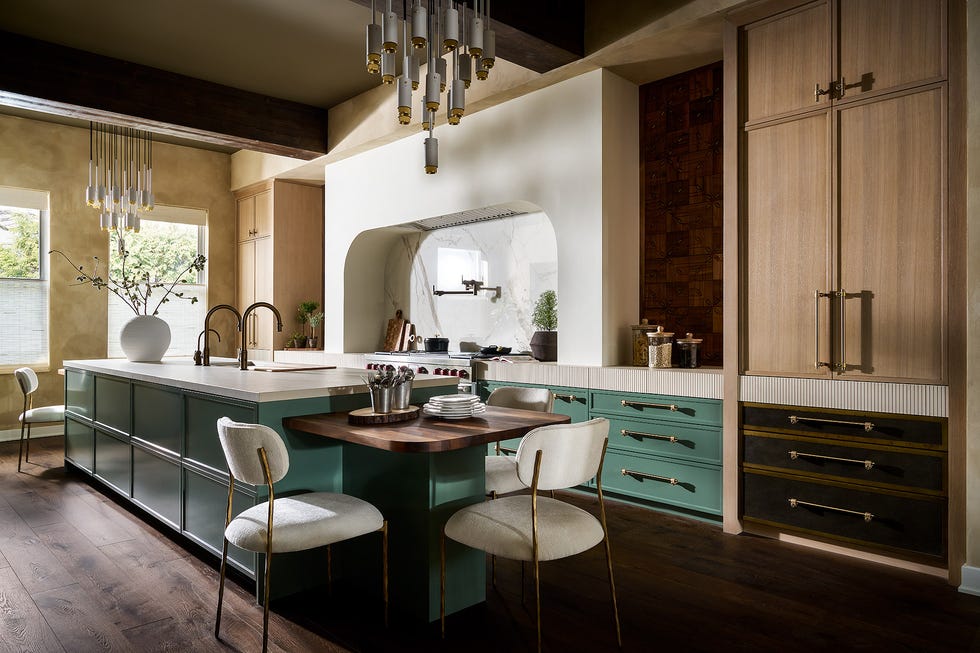 kitchen with curved hood and green cabinets
