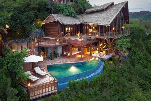 tropical villa with a pool surrounded by greenery tropical villa with a pool surrounded by greenery