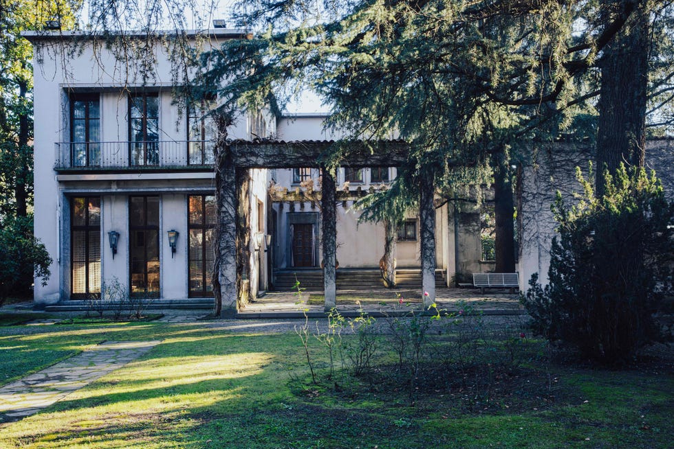 a large house with trees in front of it