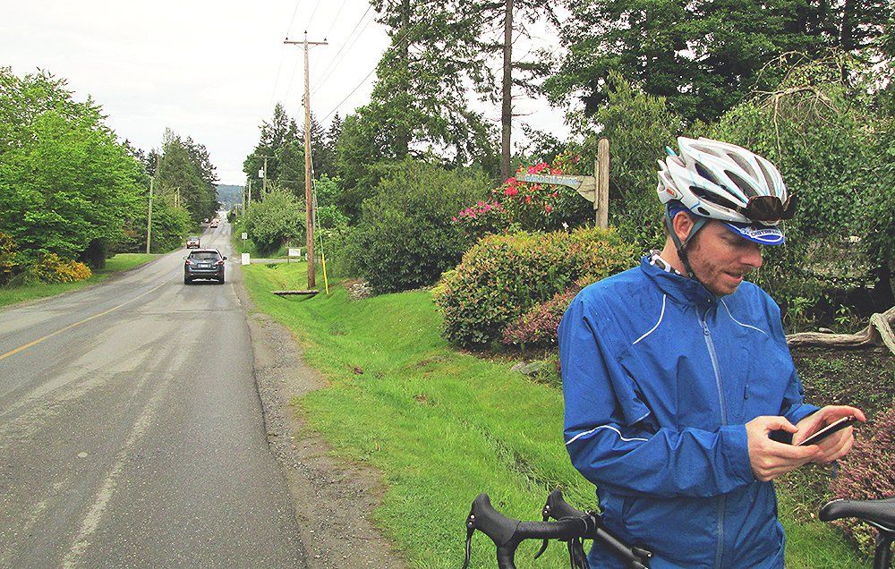 Cyclist checking phone while on a bike ride