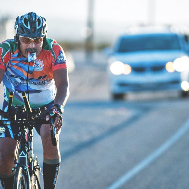 race across america cyclist fueling with an energy gel