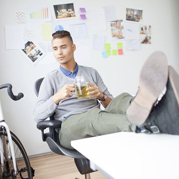 man in office with tea and bicycle