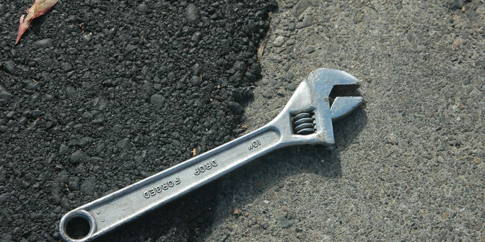 a wrench on asphalt