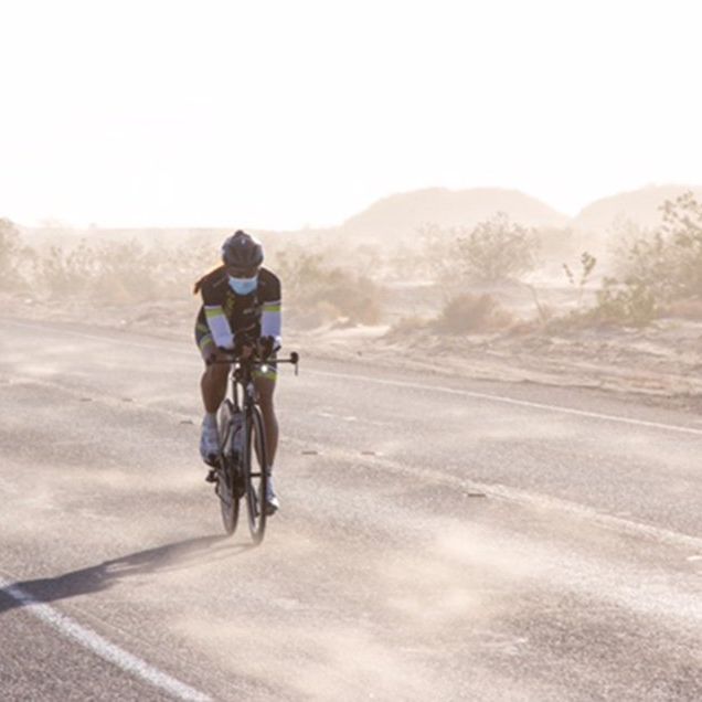RAAM winner Sarah Cooper riding on the dusty open road