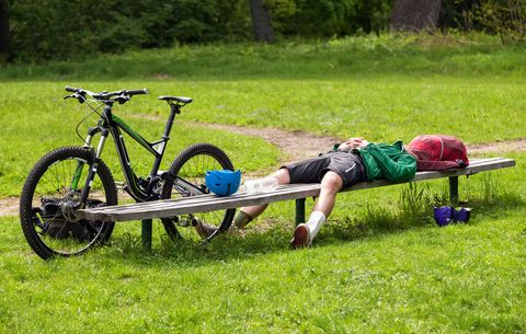 tired man near mountain bike
