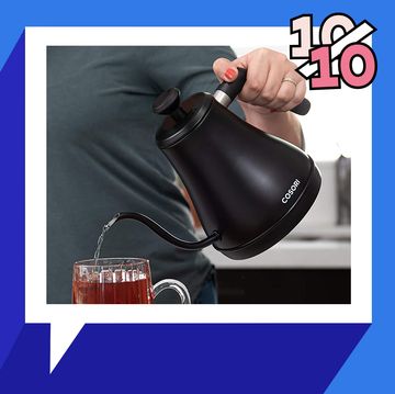 pouring hot water into tea cup from a cosori gooseneck tea kettle