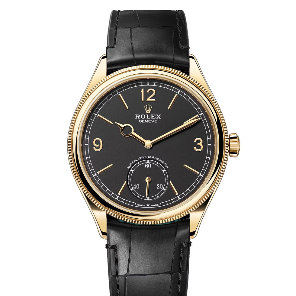 luxury wristwatch featuring a black dial and gold accents