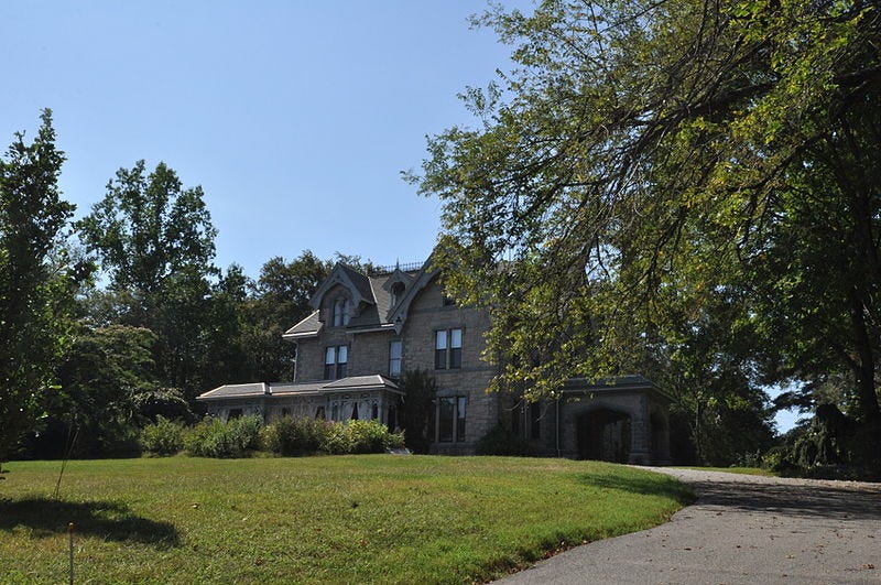a large house with trees around it