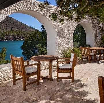 a patio with tables and chairs