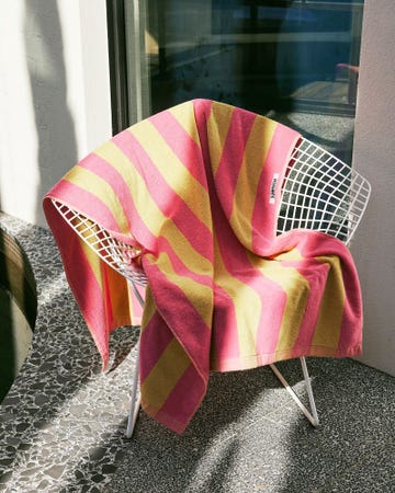 a pink and yellow towel on a chair