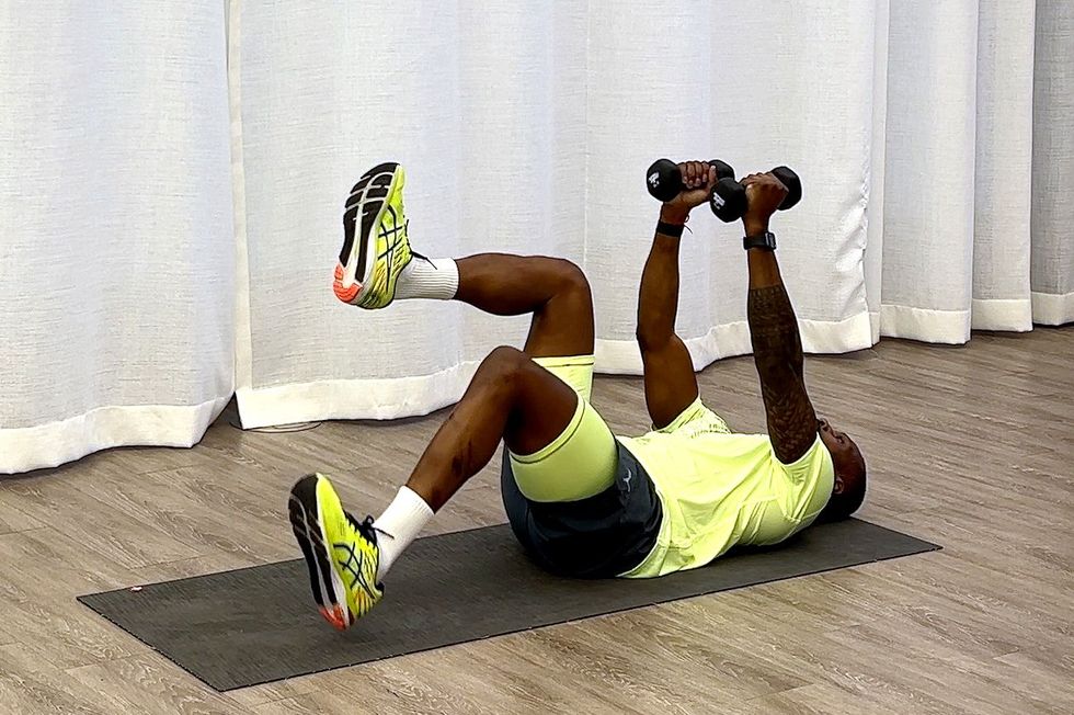 10minute core workout, yusuf jeffers practicing heel tap with dumbbell hold exercise