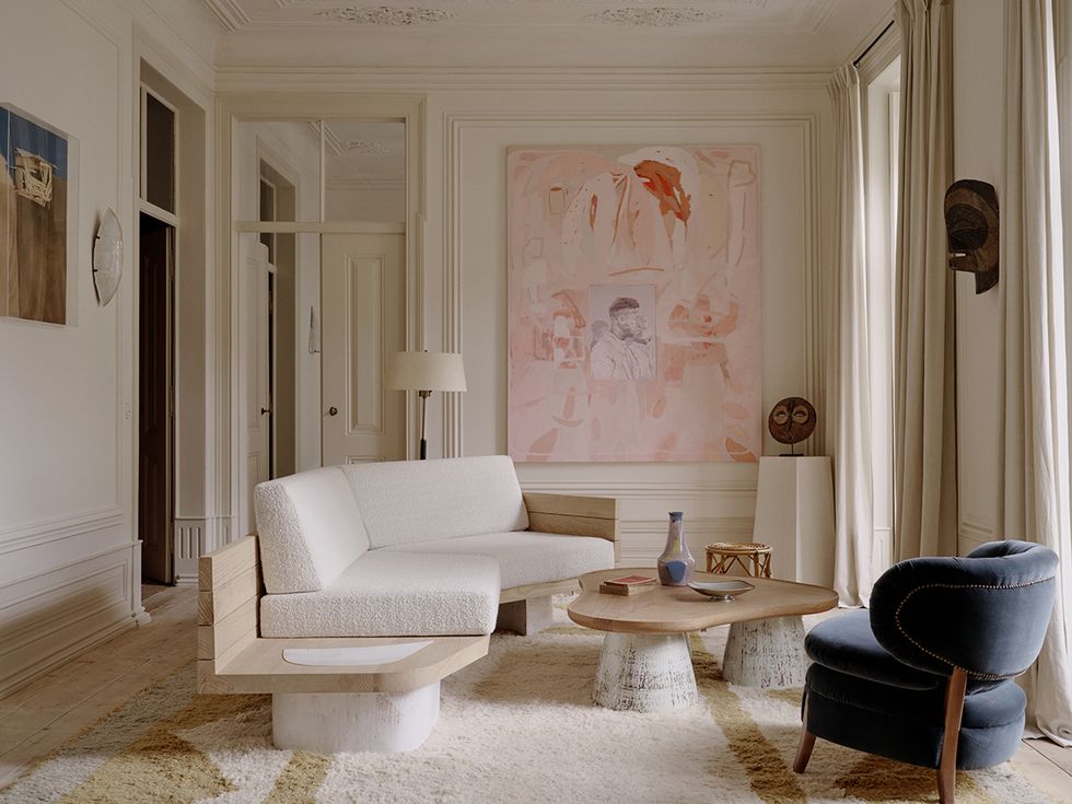 a living room with white furniture