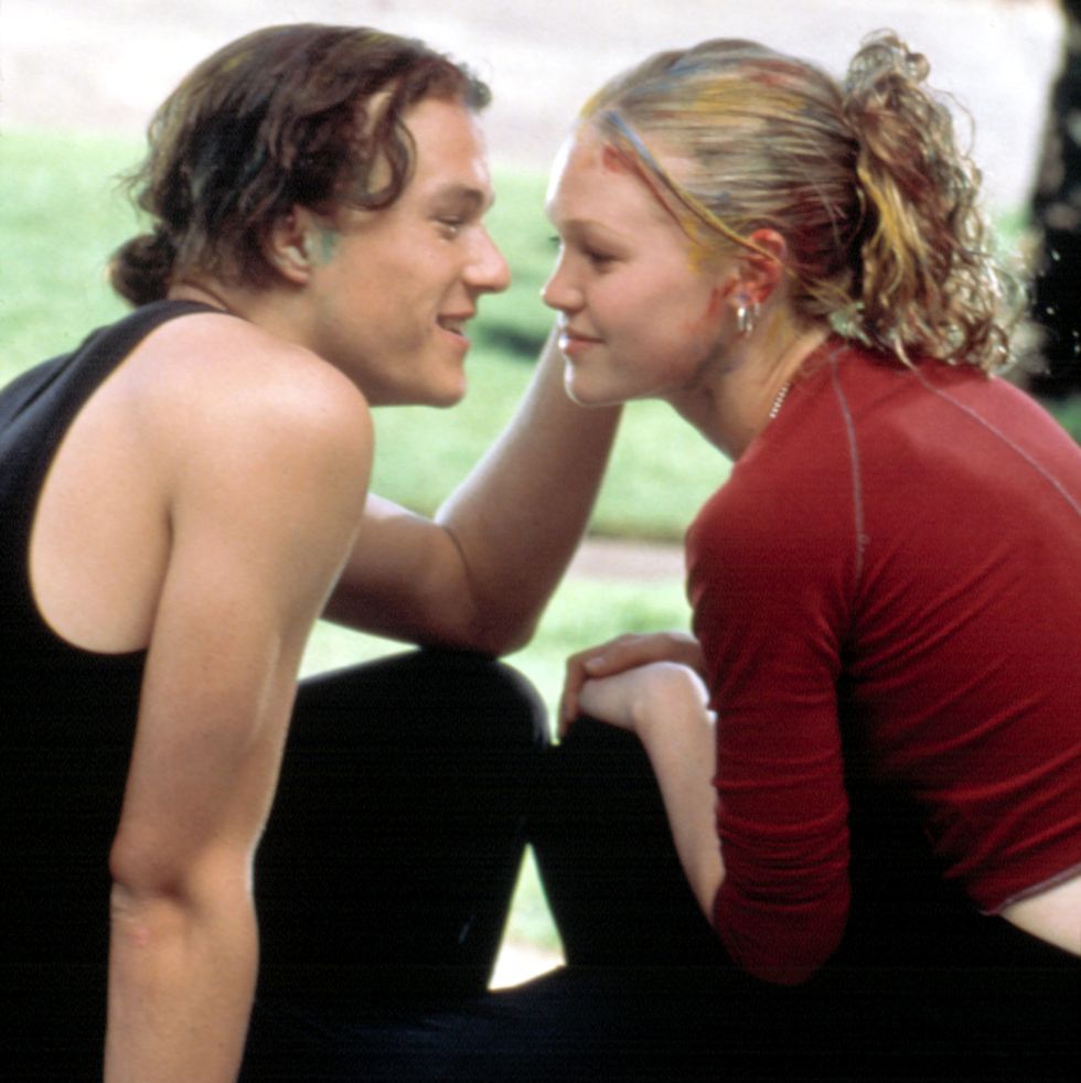 a scene from 10 things i hate about you where heath ledger's character patrick is about to kiss julia stiles' character kat, who's wearing black pants and a red long sleeve t shirt