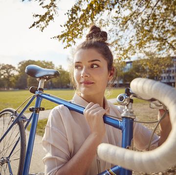vrouw tilt fiets in park