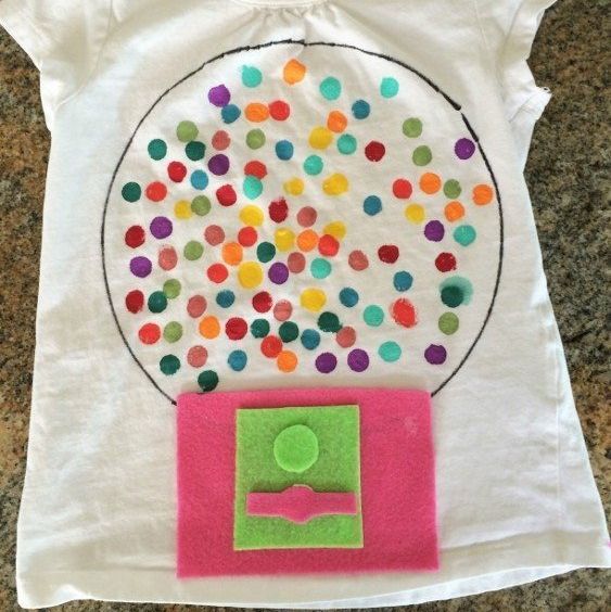 a shirt that has a felt gumball machine and 100 painted gumballs inside