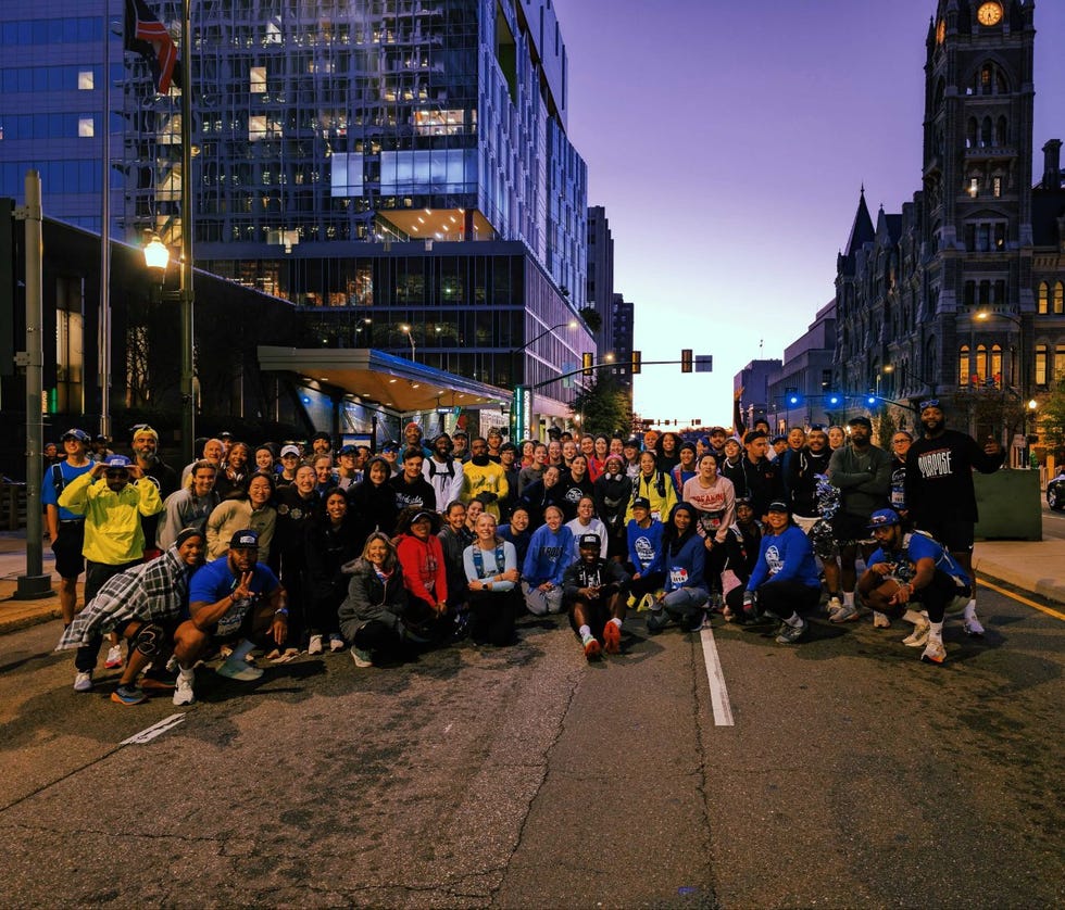 group of people posing together in an urban setting during twilight