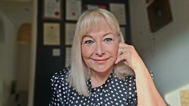 a photo of gill mulroe at her desk.