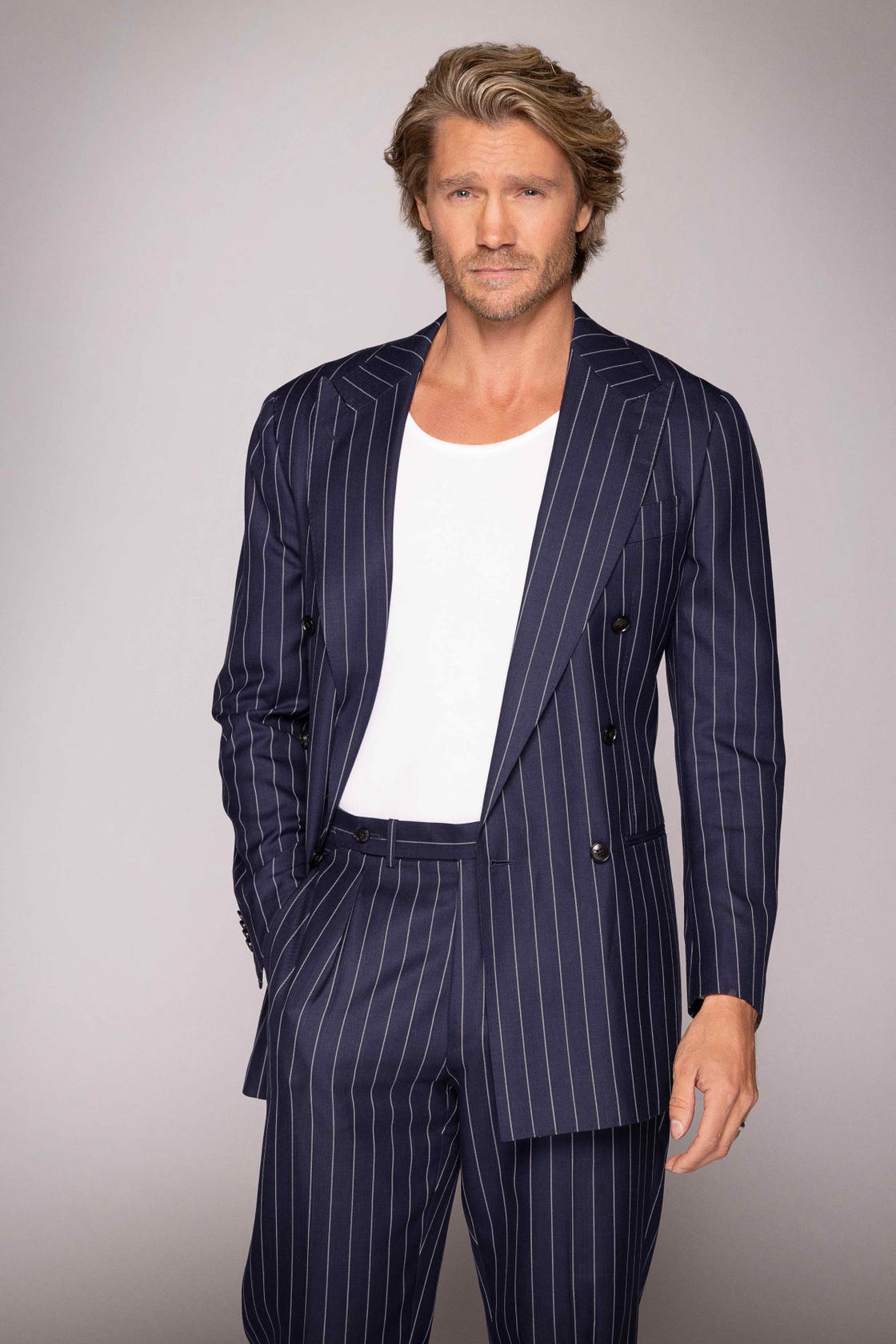 man in a striped suit with a plain shirt underneath