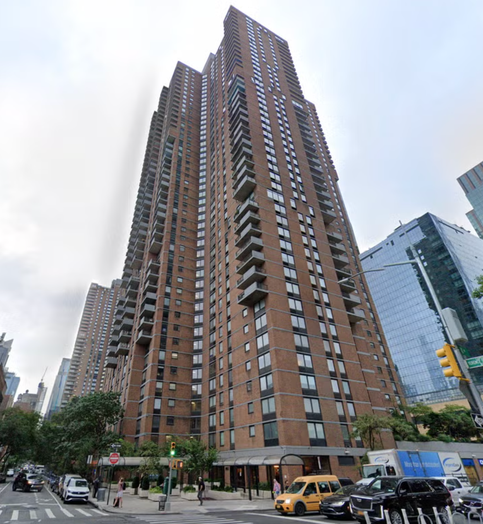 Residential skyscraper with multiple balconies and large windows.