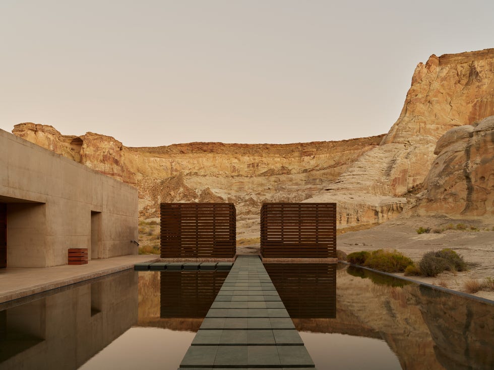 a pool surrounded by brutalist architecture