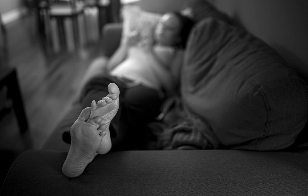 Person relaxing with their feet up on the couch