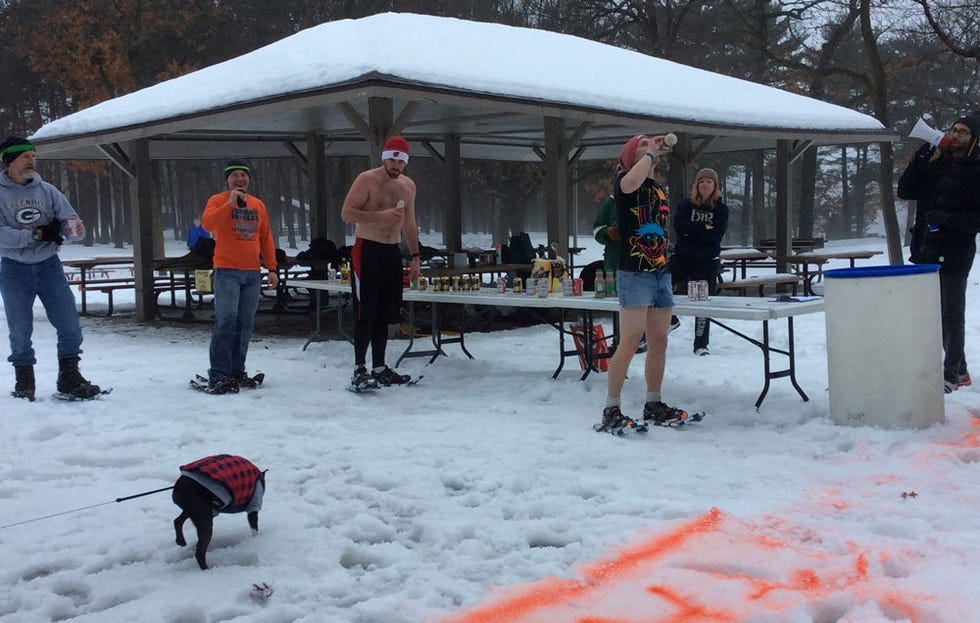 Runners in their snow shoes drinking beer 