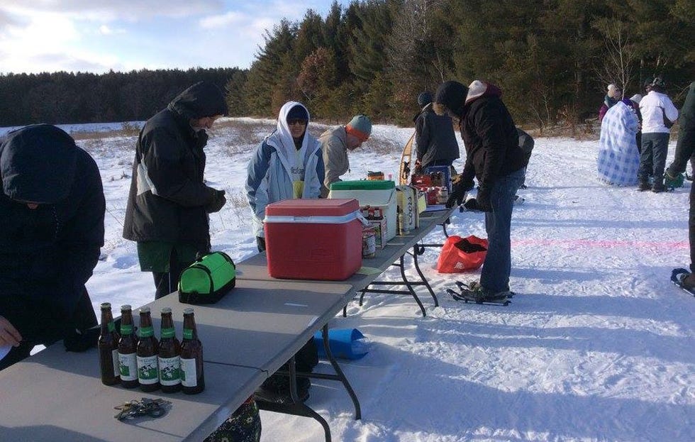 The lineup of beer coolers on a couple tables 