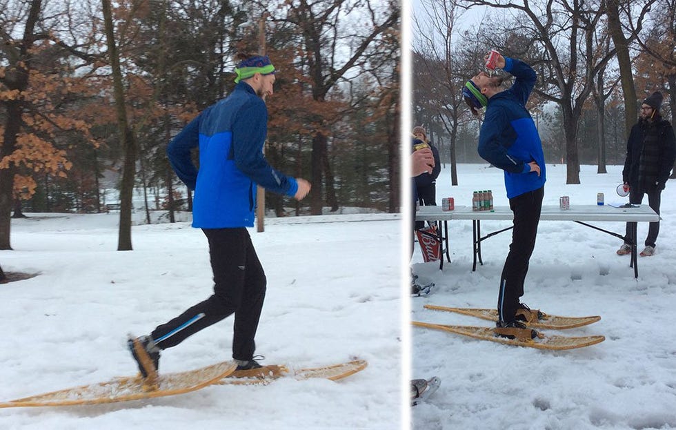 Racer running in snow shows and drinking a beer 