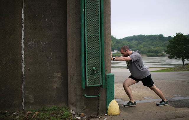 Edwin Warnick stretching on wall in Huntington, WV